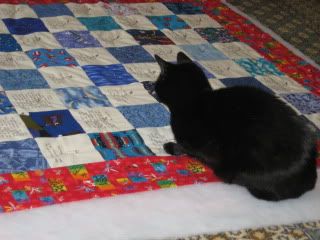 Betty inspects woodtick's quilt